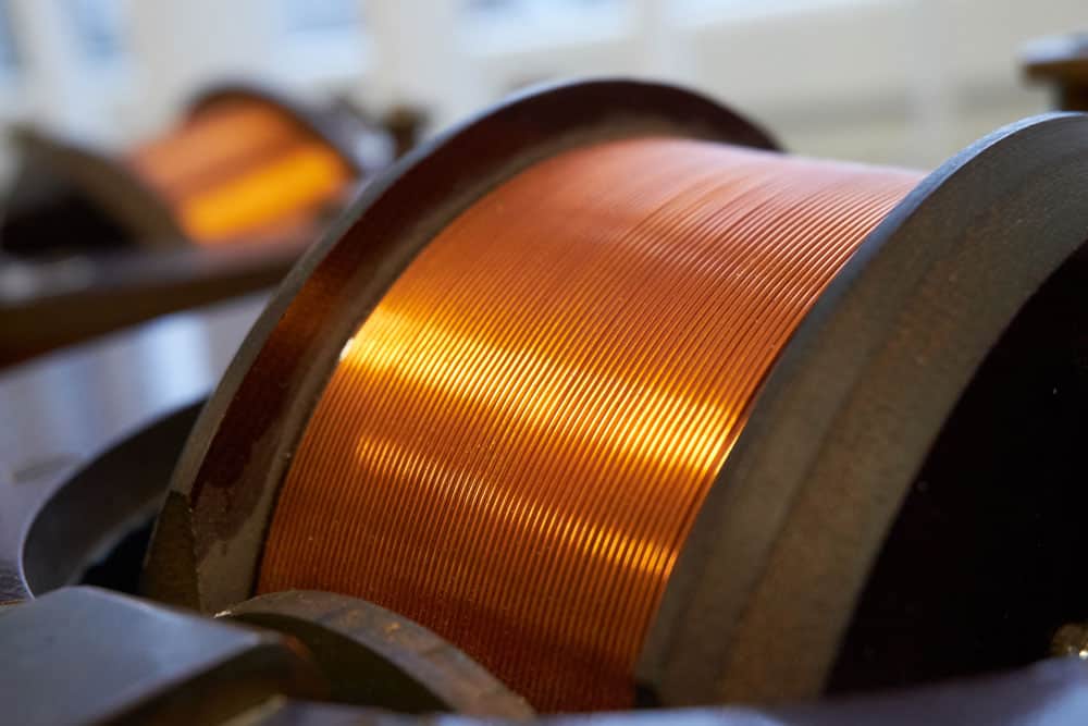 Close-up of copper coil winding used in aerospace electrical systems.
